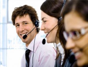 three smiling call centre operatives working